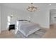 Stylishly decorated bedroom with paneled accent wall, gold chandelier, and elegant furnishings at 345 Sugarview Rd, Sugar Hill, GA 30518