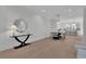 Spacious dining room with modern lighting, leading to a sleek kitchen and open floor plan at 345 Sugarview Rd, Sugar Hill, GA 30518