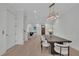 Open-concept dining area with modern light fixture and seating at 345 Sugarview Rd, Sugar Hill, GA 30518