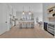 Bright kitchen with stainless appliances, an island with seating, and access to the outside at 345 Sugarview Rd, Sugar Hill, GA 30518