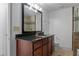 Bathroom showcasing a dark wood vanity with granite countertops and a tiled shower at 1102 Madison Se Ln # 1102, Smyrna, GA 30080