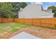 Large, newly fenced backyard with lawn, landscaping potential, and access to the home at 1164 Red Oak Cv, Tucker, GA 30084