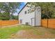 Backyard features a well-maintained lawn, fence, and access points to the house at 1164 Red Oak Cv, Tucker, GA 30084