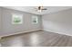 A spacious bedroom with hardwood flooring, natural light, and modern ceiling fan at 1164 Red Oak Cv, Tucker, GA 30084