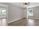 Spacious bedroom offers wood-look floors, neutral paint, and natural light from the window at 1164 Red Oak Cv, Tucker, GA 30084