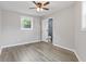 This bedroom boasts stylish flooring, ceiling fan, and a connecting door to the bathroom at 1164 Red Oak Cv, Tucker, GA 30084