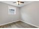 An inviting bedroom with neutral paint, hardwood flooring, and a well-lit atmosphere at 1164 Red Oak Cv, Tucker, GA 30084