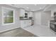 Kitchen with white cabinets, stainless steel appliances, and a view of the backyard at 1164 Red Oak Cv, Tucker, GA 30084
