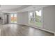 Bright living room features hardwood floors, large windows, and access to backyard at 1164 Red Oak Cv, Tucker, GA 30084