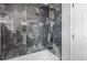 A luxurious walk-in shower features elegant tilework, modern fixtures, and a rainfall showerhead at 1164 Red Oak Cv, Tucker, GA 30084