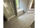 Modern bathroom featuring a walk-in shower, soaking tub, window, stylish wallpaper, and modern flooring at 3324 Whitmore Ct, Acworth, GA 30101
