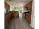 Well-equipped kitchen with stainless steel appliances, wood cabinets, and modern flooring at 3324 Whitmore Ct, Acworth, GA 30101