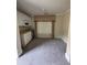 Living room with carpet, and large window with window treatments, small fridge, and overhead cabinets at 3324 Whitmore Ct, Acworth, GA 30101