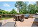 Back deck offers seating, a table with umbrella, and a relaxing place to spend time outside at 2251 Rushmore Dr, Marietta, GA 30062