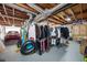 Spacious unfinished basement with exposed ceiling, and storage racks for off-season clothing at 2251 Rushmore Dr, Marietta, GA 30062