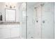 Close up view of marble-walled shower with built-in bench and double shower heads in updated bathroom at 2251 Rushmore Dr, Marietta, GA 30062