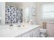Bathroom with a single vanity with a view of the toilet and a bathtub with patterned shower curtain at 2251 Rushmore Dr, Marietta, GA 30062
