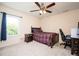 Cozy bedroom featuring a ceiling fan, natural light, and a comfortable bed with a plaid comforter at 2251 Rushmore Dr, Marietta, GA 30062