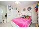 Bedroom featuring a bed with a bright pink comforter, shelving, and a large closet at 2251 Rushmore Dr, Marietta, GA 30062