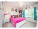 Bright bedroom featuring a pink comforter, a window with a view, and shelving for books and toys at 2251 Rushmore Dr, Marietta, GA 30062