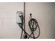 Electric vehicle charging station and power cord on a white brick wall at 2251 Rushmore Dr, Marietta, GA 30062