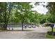 Community tennis courts and pool surrounded by lush trees and greenery at 2251 Rushmore Dr, Marietta, GA 30062