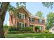 Attractive brick home with a lush green lawn, black shutters, and mature trees offering curb appeal at 2251 Rushmore Dr, Marietta, GA 30062
