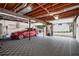 Finished garage with open ceiling, car, checkered floors and an open overhead door at 2251 Rushmore Dr, Marietta, GA 30062
