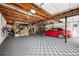 Finished garage with open ceiling, car, checkered floors and electric vehicle charging station at 2251 Rushmore Dr, Marietta, GA 30062