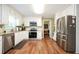 Well-lit kitchen featuring white cabinets, stainless appliances, and hardwood floors at 2251 Rushmore Dr, Marietta, GA 30062
