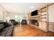 Spacious living room with hardwood floors, brick fireplace and built-in shelves, creating a cozy atmosphere at 2251 Rushmore Dr, Marietta, GA 30062