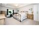 Relaxing main bedroom with a decorative metal bed frame, soft carpet, and serene decor for comfort at 2251 Rushmore Dr, Marietta, GA 30062