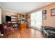 Comfortable office with shelves, hardwood floors, a work area, and a relaxing sitting space at 2251 Rushmore Dr, Marietta, GA 30062