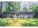 Backyard featuring patio and green grass with a view of the home at 914 Hemingway Rd, Stone Mountain, GA 30088