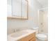 Bathroom featuring vanity sink, toilet, and shower with tile surround at 914 Hemingway Rd, Stone Mountain, GA 30088
