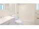 Bathroom featuring gray vanity, toilet, and shower-tub combination with white tile surround at 914 Hemingway Rd, Stone Mountain, GA 30088