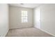 Neutral bedroom featuring carpet flooring, window, and closet at 914 Hemingway Rd, Stone Mountain, GA 30088