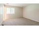 Bedroom with neutral walls, carpet and a window bringing in natural light at 914 Hemingway Rd, Stone Mountain, GA 30088