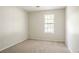 Cozy bedroom featuring carpet flooring, window, and neutral wall color at 914 Hemingway Rd, Stone Mountain, GA 30088