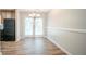 Bright dining area featuring wood floors, classic chandelier and access to outdoor space through glass paneled doors at 914 Hemingway Rd, Stone Mountain, GA 30088
