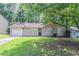 Charming one-story home featuring a stone chimney, attached garage, and a well-maintained front lawn at 914 Hemingway Rd, Stone Mountain, GA 30088