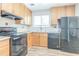 Kitchen featuring wood cabinetry, stainless appliances, and modern fixtures at 914 Hemingway Rd, Stone Mountain, GA 30088