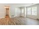 Spacious living room featuring hardwood floors, bright windows, and neutral decor throughout at 914 Hemingway Rd, Stone Mountain, GA 30088