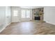 Inviting living room featuring a stone fireplace, wood floors, and windows with abundant natural light at 914 Hemingway Rd, Stone Mountain, GA 30088