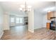 Open-concept living room and kitchen with wood floors, stone fireplace, and stainless steel appliances at 914 Hemingway Rd, Stone Mountain, GA 30088