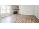 Open living room featuring hardwood floors, a stone fireplace, and sun-filled windows at 914 Hemingway Rd, Stone Mountain, GA 30088
