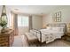 Tranquil main bedroom with a wrought iron bed frame, accent furniture, and soft natural light at 914 Hemingway Rd, Stone Mountain, GA 30088
