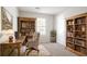 Functional home office with wooden desk, shelving, and a comfortable chair near a window at 914 Hemingway Rd, Stone Mountain, GA 30088