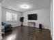 Finished basement with a TV, hardwood floors, and a small seating area at 2736 Bell Se Dr, Smyrna, GA 30080