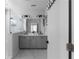 Modern bathroom featuring a dual sink vanity with gray cabinets and a glass-enclosed shower at 2736 Bell Se Dr, Smyrna, GA 30080